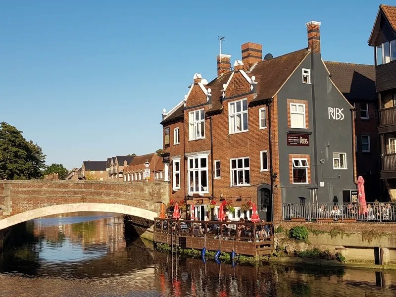 The Ribs of Beef beside Fye Bridge in Norwich, its riverside deck set out with tables above the Wensum